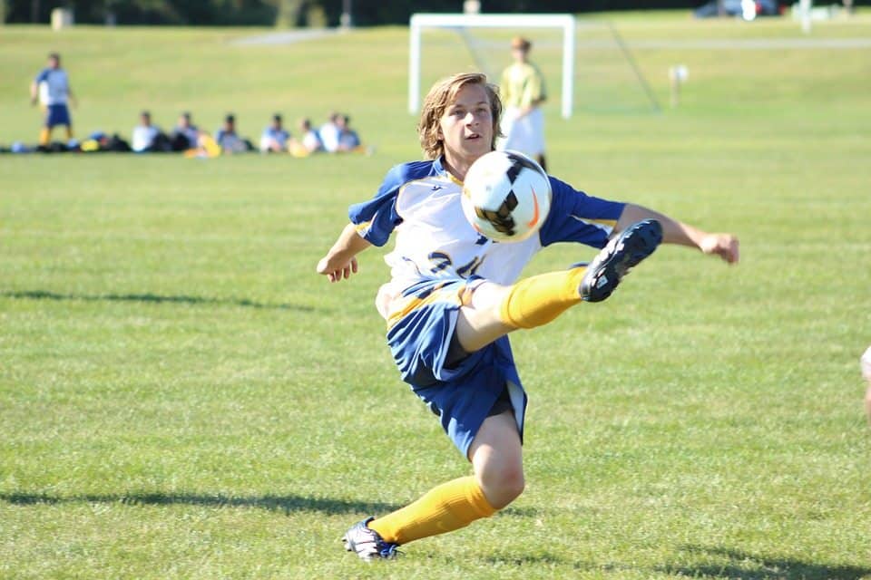 boy kicking soccer ball