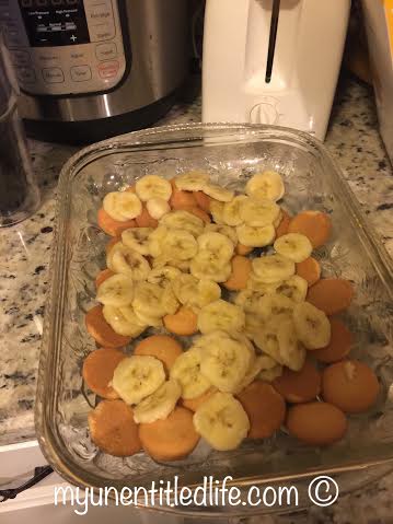 cut up bananas and add nilla wafers to pan